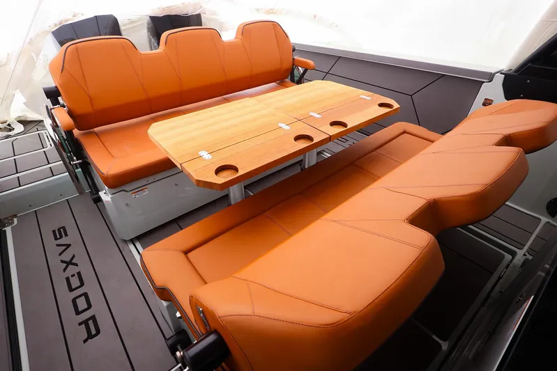  Yacht Photos Pics 2023 Saxdor 320 GTO interior with orange seating and wooden table.