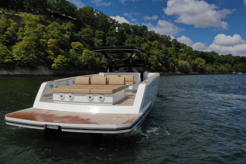  Yacht Photos Pics 2024 Pardo Yachts P43 cruising on a scenic lake with lush green shoreline.