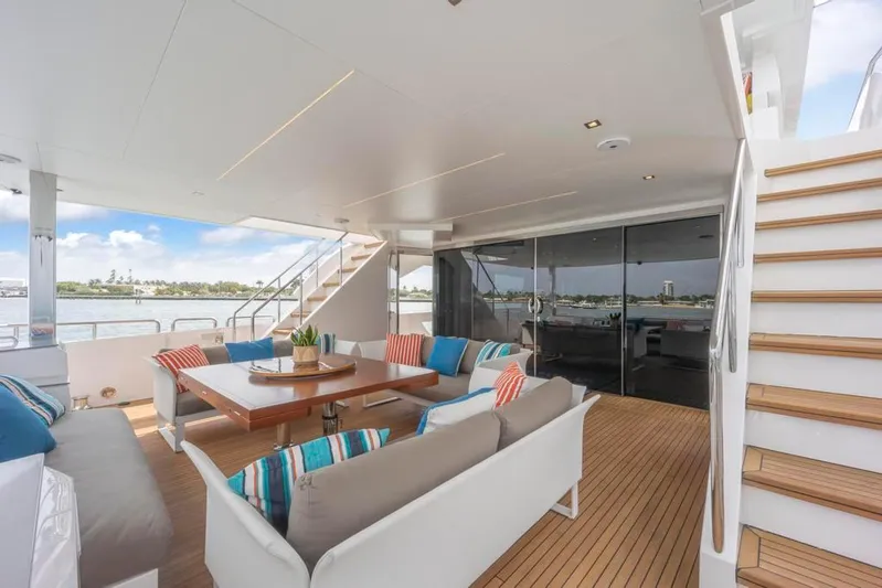 Bella Tu Yacht Photos Pics Aft Deck Sofas Cocktail Table and Stairs to Boat Deck