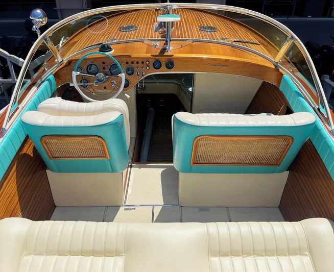 Turquoise Yacht Photos Pics 1974 Riva Aquarama Special boat interior with wooden dashboard and turquoise accents.