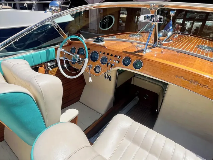 Turquoise Yacht Photos Pics 1974 Riva Aquarama Special boat interior with wooden dashboard and turquoise accents.