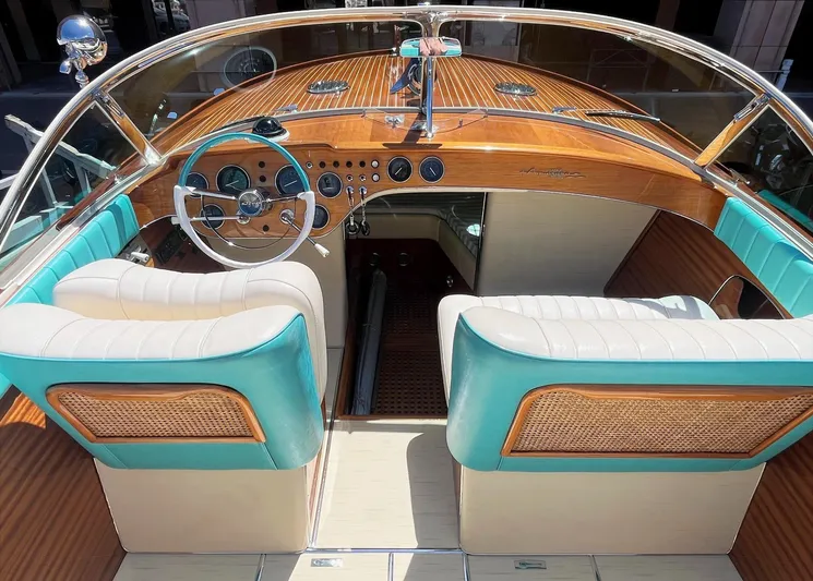 Turquoise Yacht Photos Pics 1974 Riva Aquarama Special boat interior with wooden dashboard and turquoise seating.