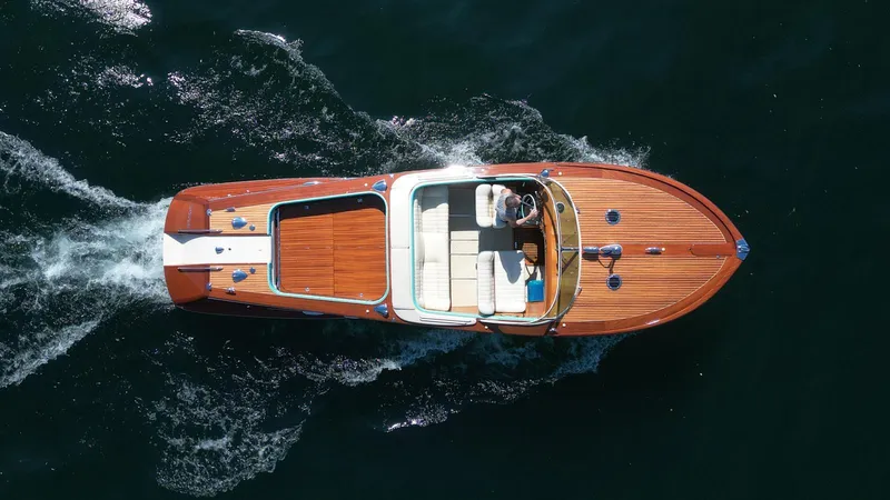 Turquoise Yacht Photos Pics Aerial view of a 1974 Riva Aquarama Special boat cruising on water.