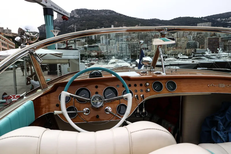 Turquoise Yacht Photos Pics Interior view of a 1974 Riva Aquarama Special boat, showcasing its classic wooden dashboard.
