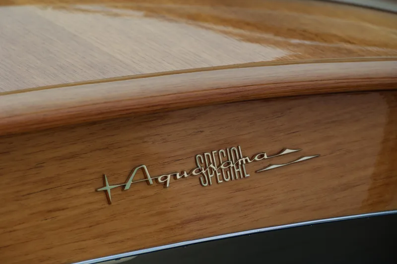 Turquoise Yacht Photos Pics 1974 Riva Aquarama Special wooden boat detail with elegant logo.