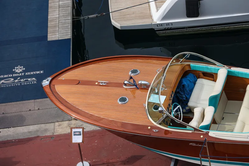 Turquoise Yacht Photos Pics 1974 Riva Aquarama Special boat docked at Monaco Boat Service, showcasing elegant wooden design.