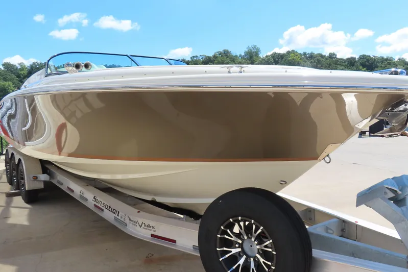  Yacht Photos Pics 2018 Chris Craft Launch 34 boat on trailer under clear blue sky.