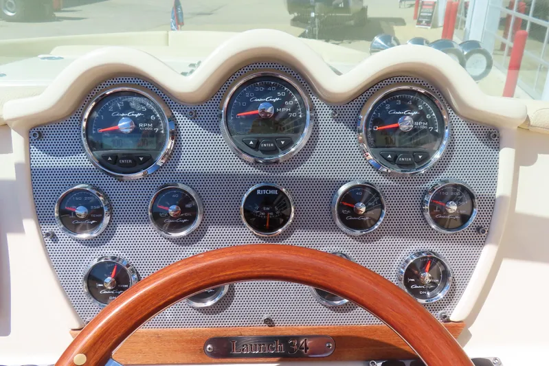  Yacht Photos Pics Dashboard of a 2018 Chris Craft Launch 34 boat with gauges and wooden steering wheel.