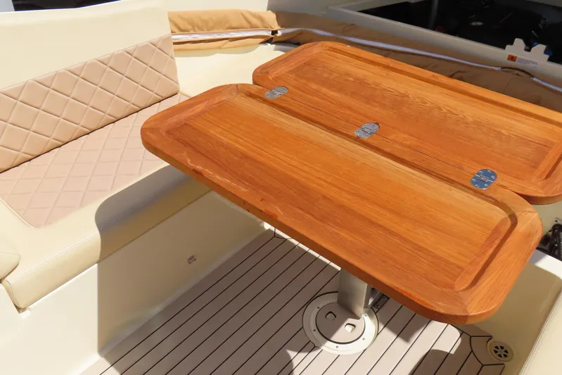  Yacht Photos Pics Luxurious interior of 2018 Chris Craft Launch 34 with wooden table and cushioned seating.