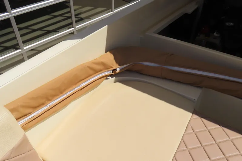  Yacht Photos Pics 2018 Chris Craft Launch 34 interior seating with beige upholstery and diamond stitching.