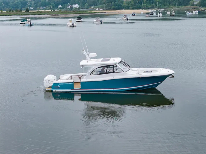 Even Flow Yacht Photos Pics 2021 Southport 33 DC boat on calm water with scenic background.