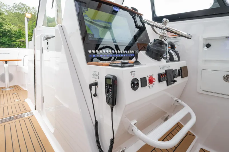 Even Flow Yacht Photos Pics 2021 Southport 33 DC boat helm with modern controls and navigation system.