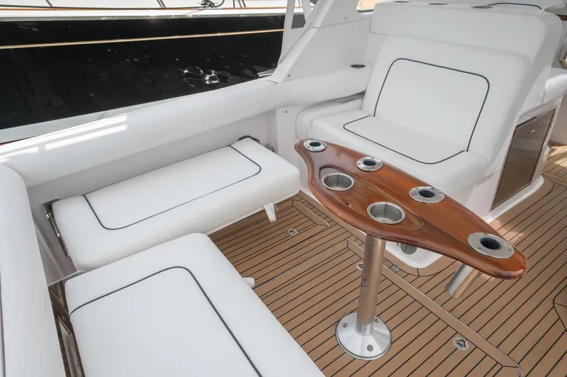 Even Flow Yacht Photos Pics 2021 Southport 33 DC boat interior with white seating and wooden table.