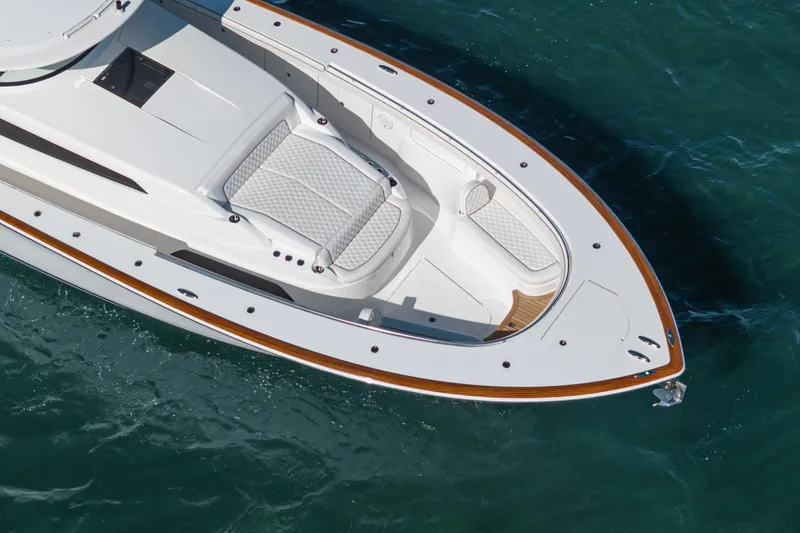  Yacht Photos Pics 2024 Valhalla Boatworks V-55, sleek design, white hull, wooden accents, cruising on blue water.