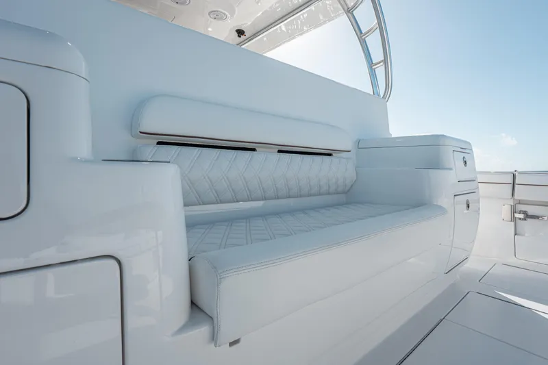  Yacht Photos Pics Luxurious seating on 2024 Valhalla Boatworks V-55, featuring sleek white design and storage.
