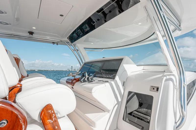  Yacht Photos Pics 2024 Valhalla Boatworks V-55 cockpit with luxurious seating and advanced controls on open water.