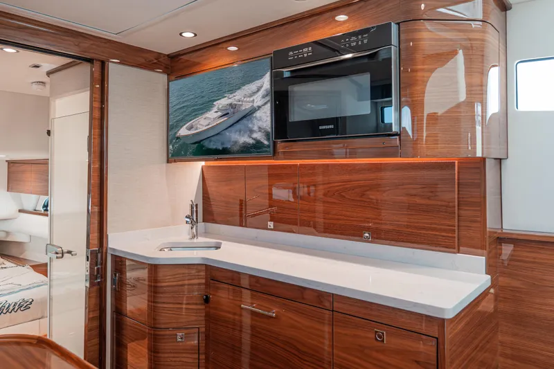  Yacht Photos Pics Luxurious interior of 2024 Valhalla Boatworks V-55 with sleek wood finish and modern amenities.