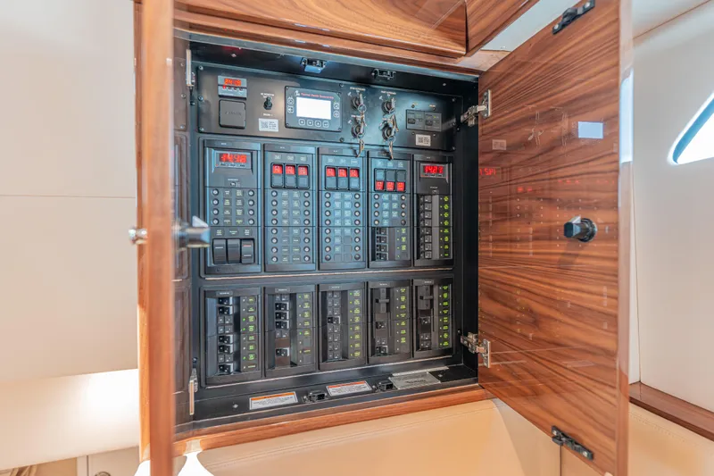  Yacht Photos Pics Electrical panel inside 2024 Valhalla Boatworks V-55 yacht, featuring modern controls and wood finish.