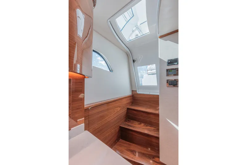 Yacht Photos Pics Interior of 2024 Valhalla Boatworks V-55, featuring wooden stairs and modern design elements.