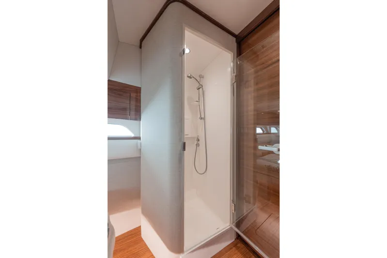  Yacht Photos Pics 2024 Valhalla Boatworks V-55 shower interior with modern design and wooden accents.