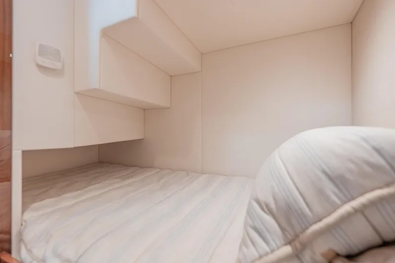  Yacht Photos Pics 2024 Valhalla Boatworks V-55 cabin interior with cozy bedding and modern design.