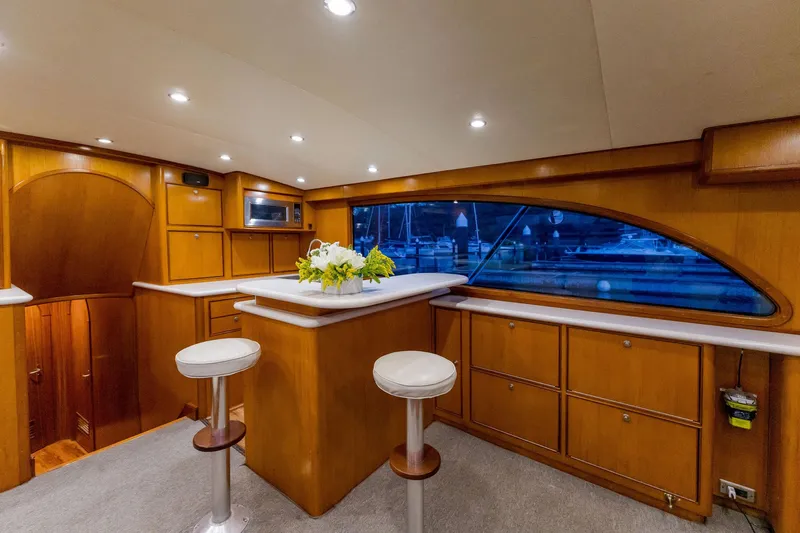 Seacario Yacht Photos Pics Luxurious interior of 2001 Custom Carolina Sportfish yacht with elegant wood finish and seating.