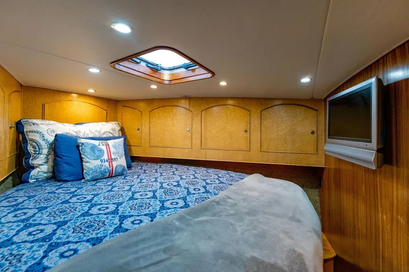 Seacario Yacht Photos Pics Luxurious cabin interior of 2001 Custom Carolina Sportfish with cozy bedding and TV.