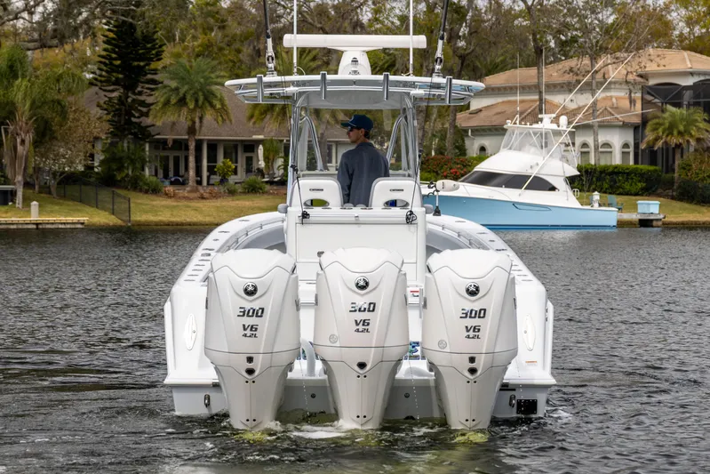  Yacht Photos Pics 2022 Contender 35 ST boat with triple 300 V6 engines on a calm waterway.
