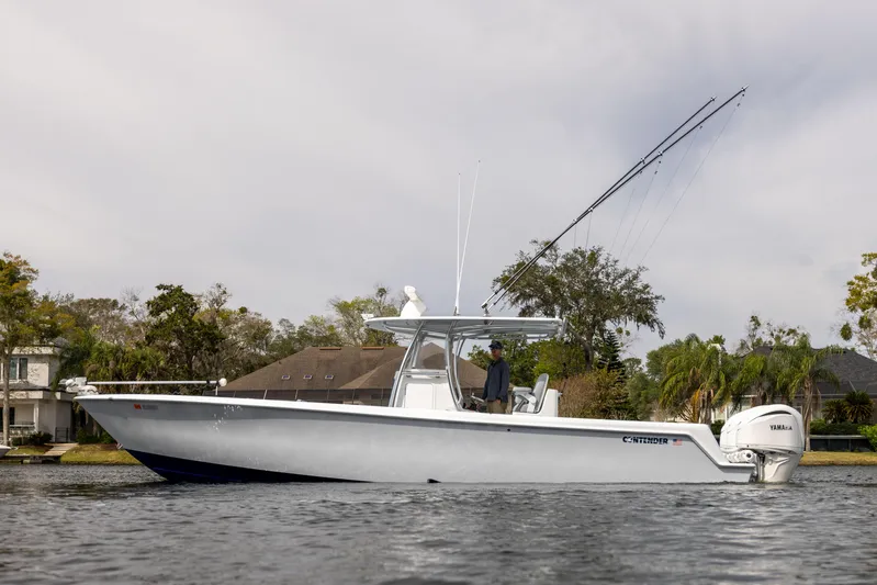  Yacht Photos Pics 2022 Contender 35 ST boat on calm water, featuring sleek design and powerful engines.