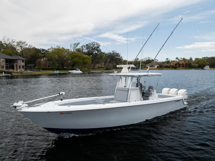  Yacht Photos Pics 2022 Contender 35 ST boat cruising on a calm lake with fishing rods.