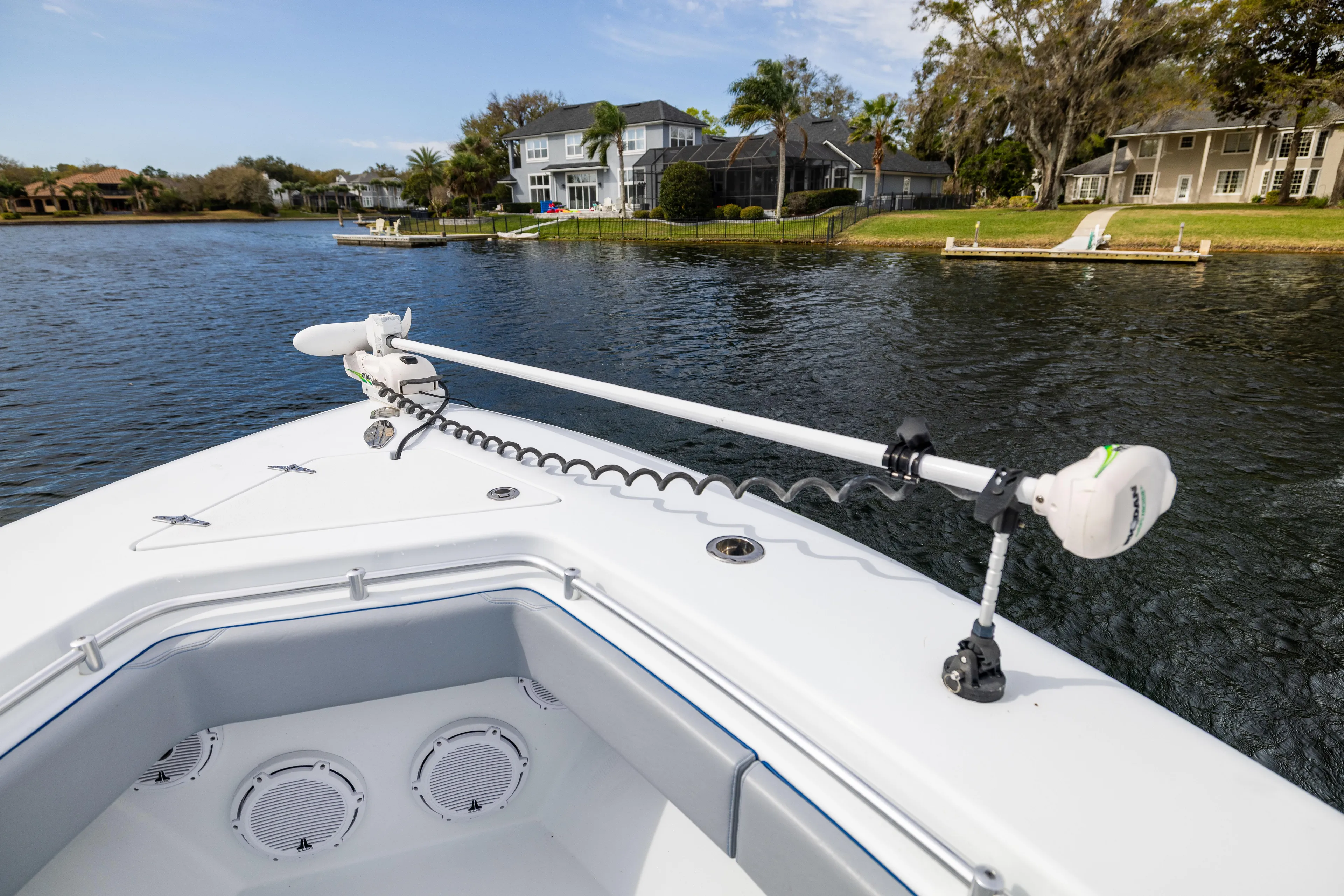  Yacht Photos Pics 2022 Contender 35 ST boat on a serene lake with residential backdrop.