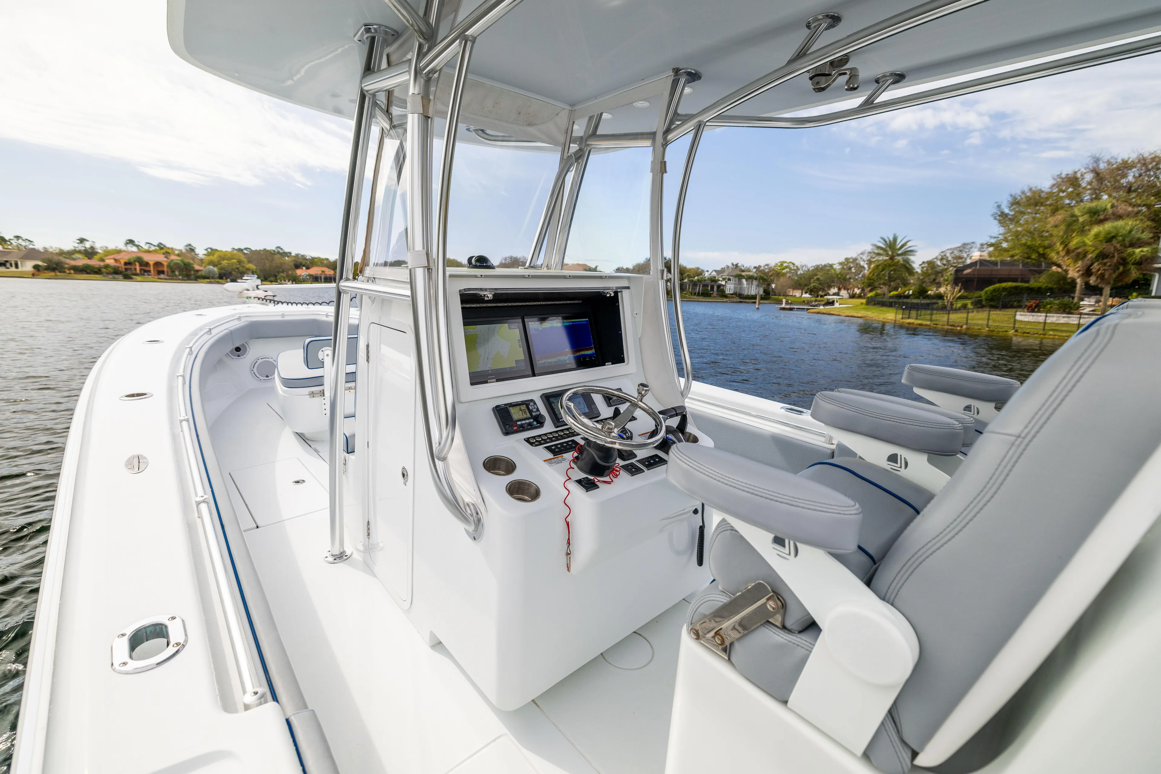  Yacht Photos Pics 2022 Contender 35 ST boat interior with modern helm and seating on a sunny day.