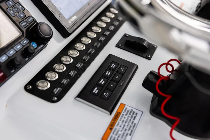  Yacht Photos Pics Control panel of 2022 Contender 35 ST boat with buttons and display screens.