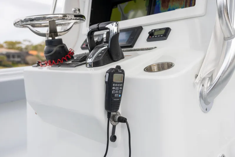  Yacht Photos Pics 2022 Contender 35 ST boat console with steering wheel and communication equipment.