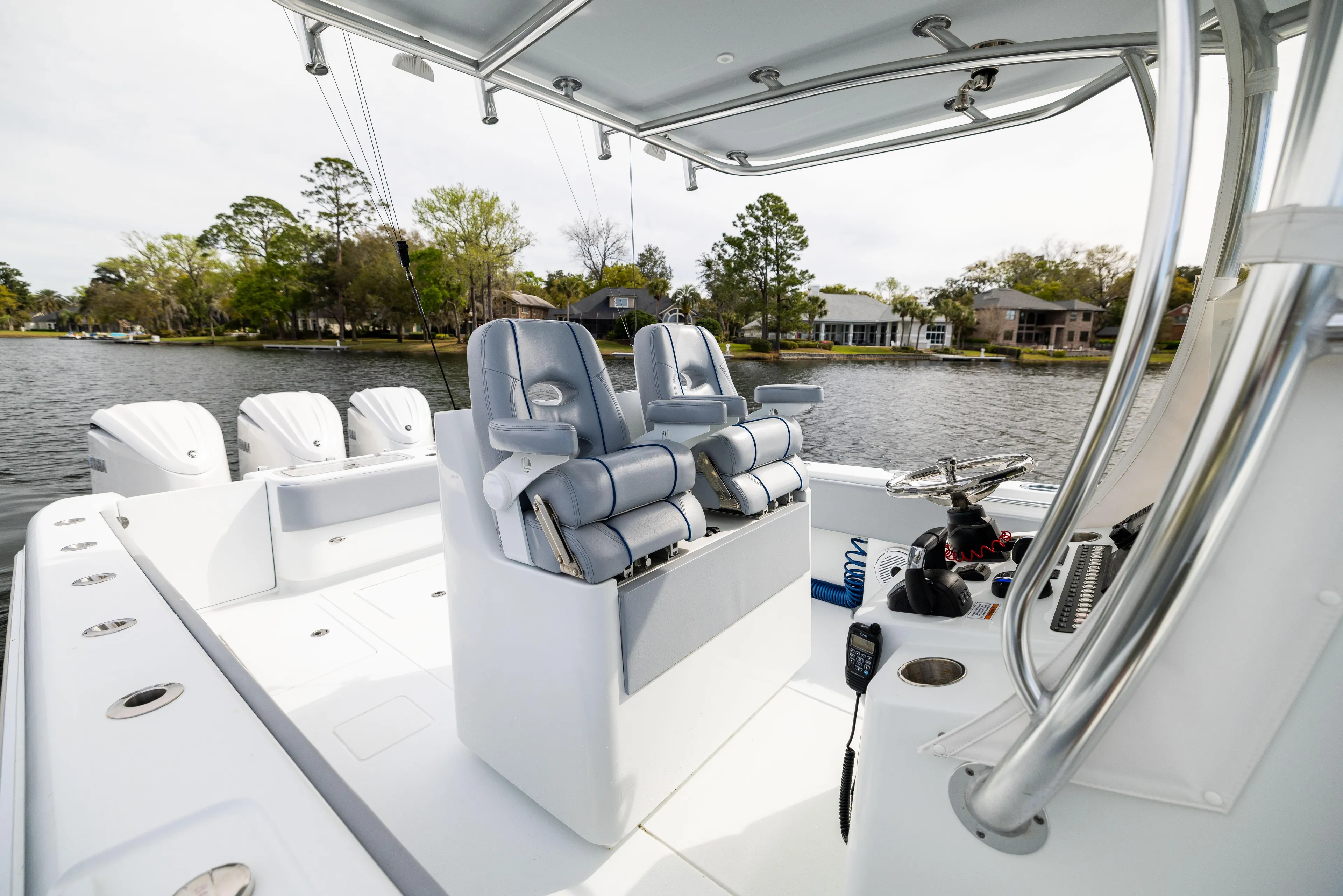  Yacht Photos Pics 2022 Contender 35 ST boat interior with dual seats on a calm lake.