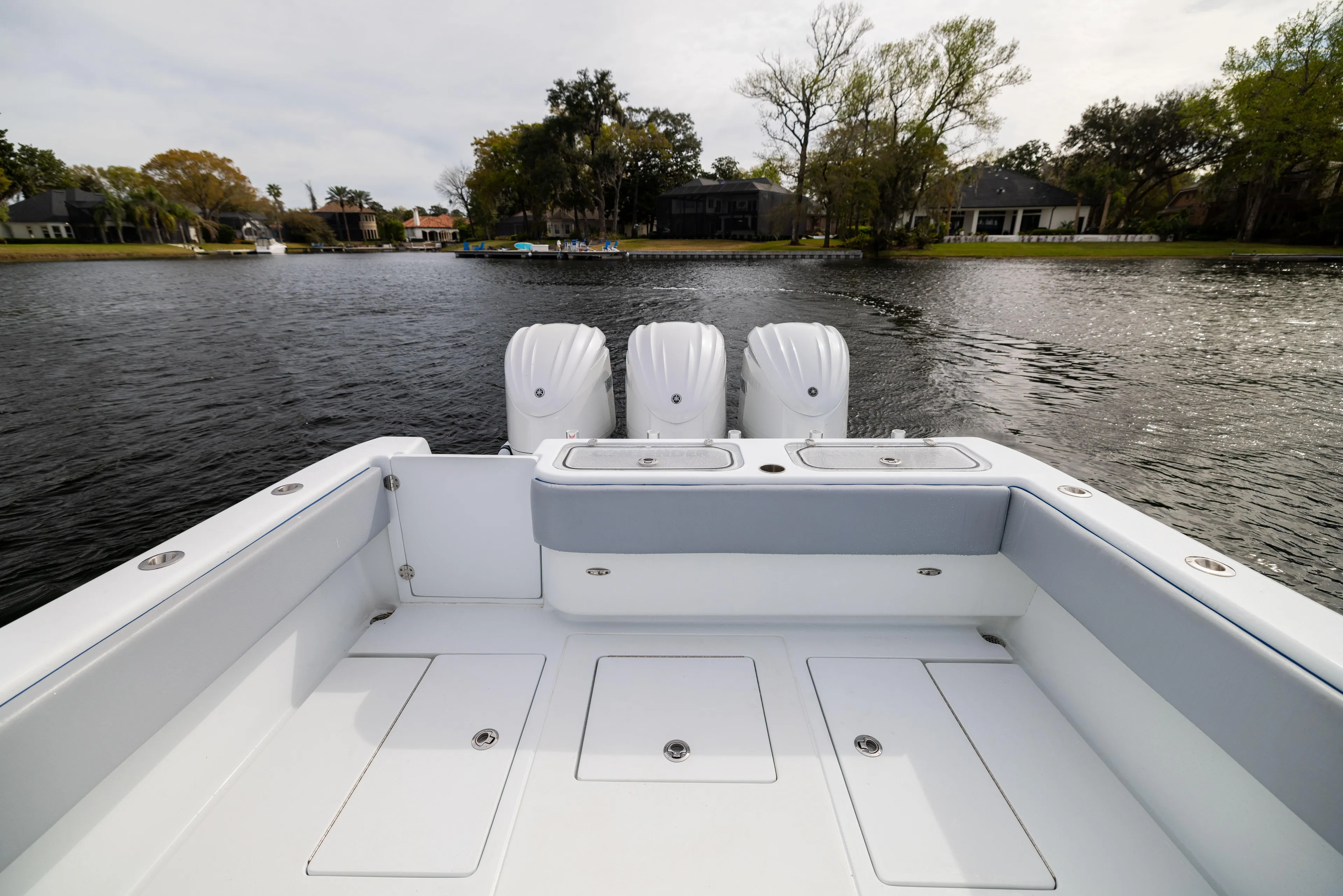  Yacht Photos Pics 2022 Contender 35 ST boat with triple engines on a calm lake.