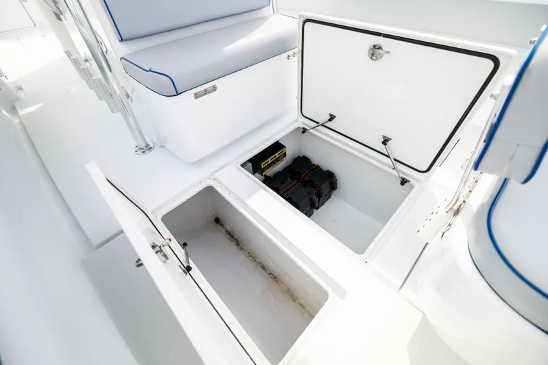  Yacht Photos Pics 2022 Contender 35 ST boat storage compartments with open hatches, showcasing interior space.