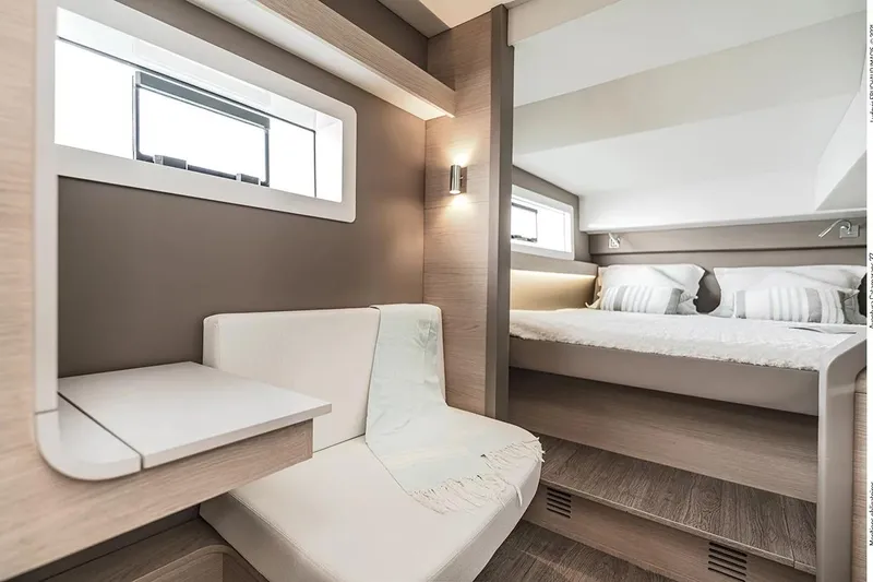  Yacht Photos Pics Interior of 2025 Aventura 37 Trawler, featuring modern seating and cozy sleeping area.