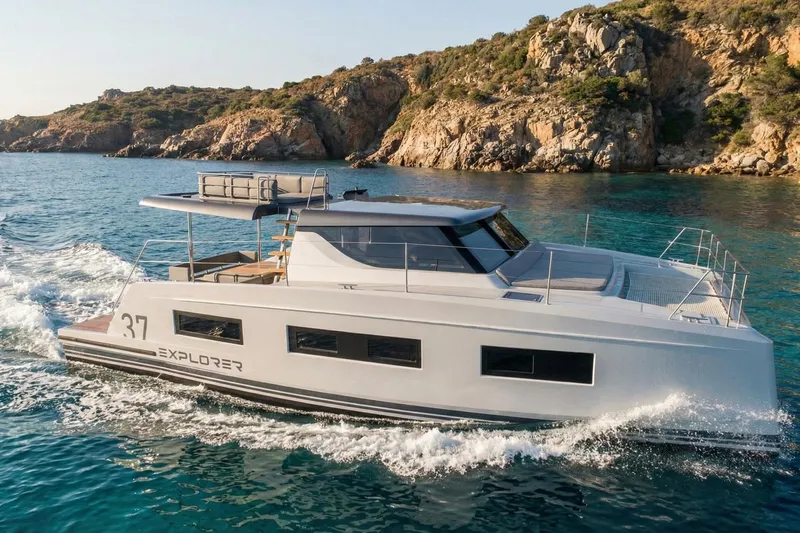  Yacht Photos Pics 2025 Aventura 37 Trawler cruising near rocky coastline.