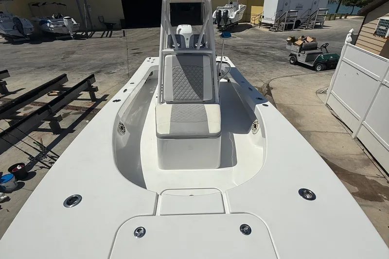  Yacht Photos Pics 2022 ZCB 26 Freemason boat with spacious deck and seating, docked at a marina.