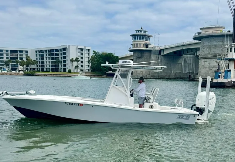  Yacht Photos Pics 2022 ZCB 26 Freemason boat cruising near a bridge and modern buildings.