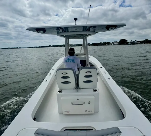  Yacht Photos Pics 2022 ZCB 26 Freemason boat cruising on a calm lake under cloudy skies.