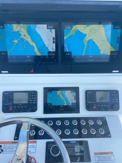  Yacht Photos Pics 2024 Contender 35 ST boat dashboard with navigation screens and controls.