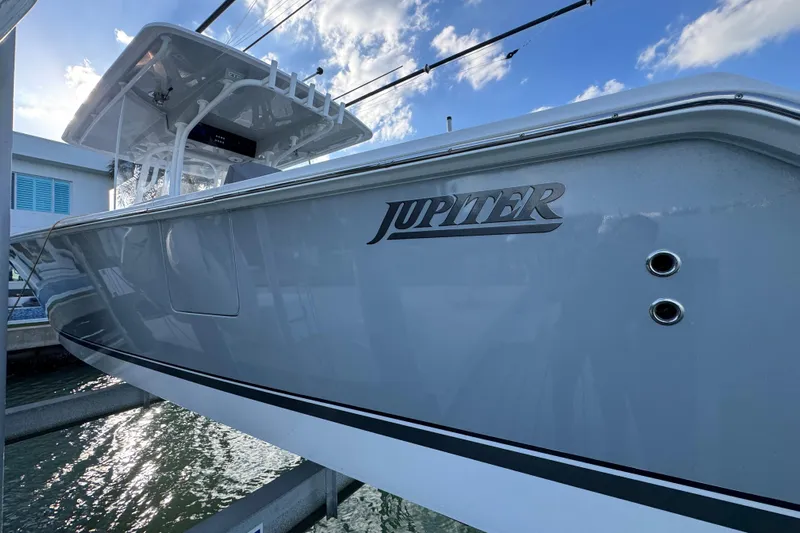 High Steaks Yacht Photos Pics 2024 Jupiter 38 HFS boat docked, showcasing sleek design and branding under a blue sky.