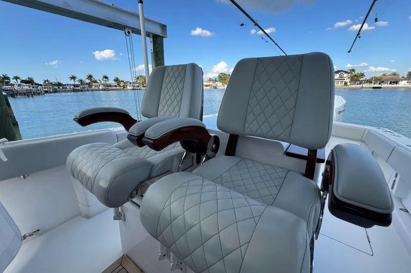 High Steaks Yacht Photos Pics Luxurious seating on 2024 Jupiter 38 HFS boat, featuring quilted upholstery and scenic waterfront view.