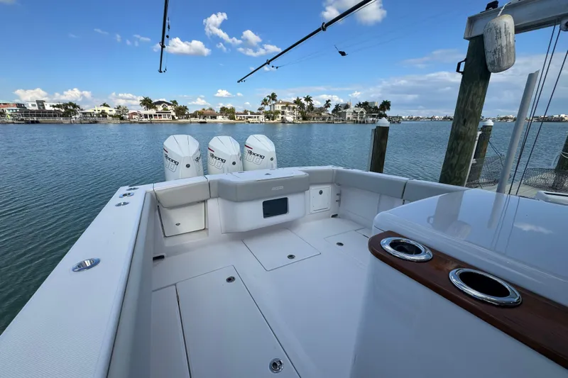 High Steaks Yacht Photos Pics 2024 Jupiter 38 HFS boat with triple engines docked by waterfront homes.