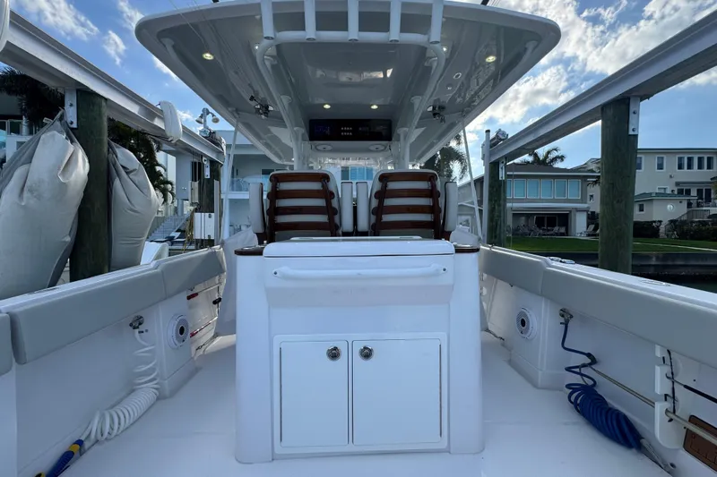 High Steaks Yacht Photos Pics 2024 Jupiter 38 HFS boat interior with seating and storage, docked under a blue sky.