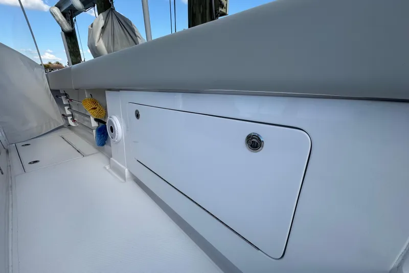 High Steaks Yacht Photos Pics 2024 Jupiter 38 HFS boat deck with storage compartment and cleaning brushes.