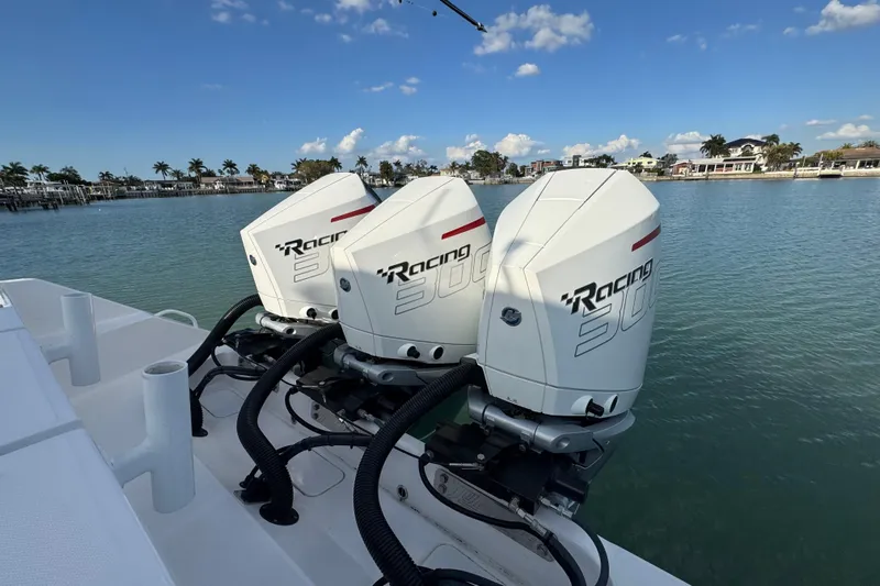 High Steaks Yacht Photos Pics 2024 Jupiter 38 HFS boat with triple Racing 300 engines on a sunny waterfront.