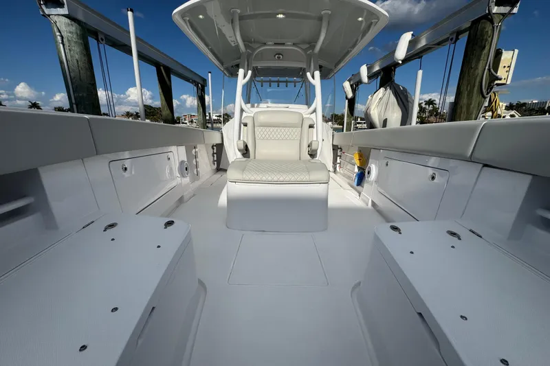 High Steaks Yacht Photos Pics 2024 Jupiter 38 HFS boat interior with seating and storage, docked under a clear sky.